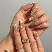 Gilded Magnolia Veil Long Almond press-on nails, modeled detail view 1