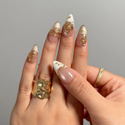 Gilded Magnolia Veil Long Almond press-on nails, modeled detail view 2