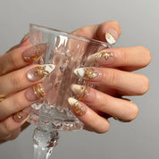 Gilded Magnolia Veil Long Almond press-on nails, modeled detail view 3
