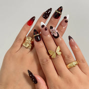Cherry Noir Petals Long Almond press-on nails, modeled detail view 1