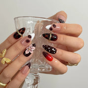 Cherry Noir Petals Long Almond press-on nails, modeled detail view 2
