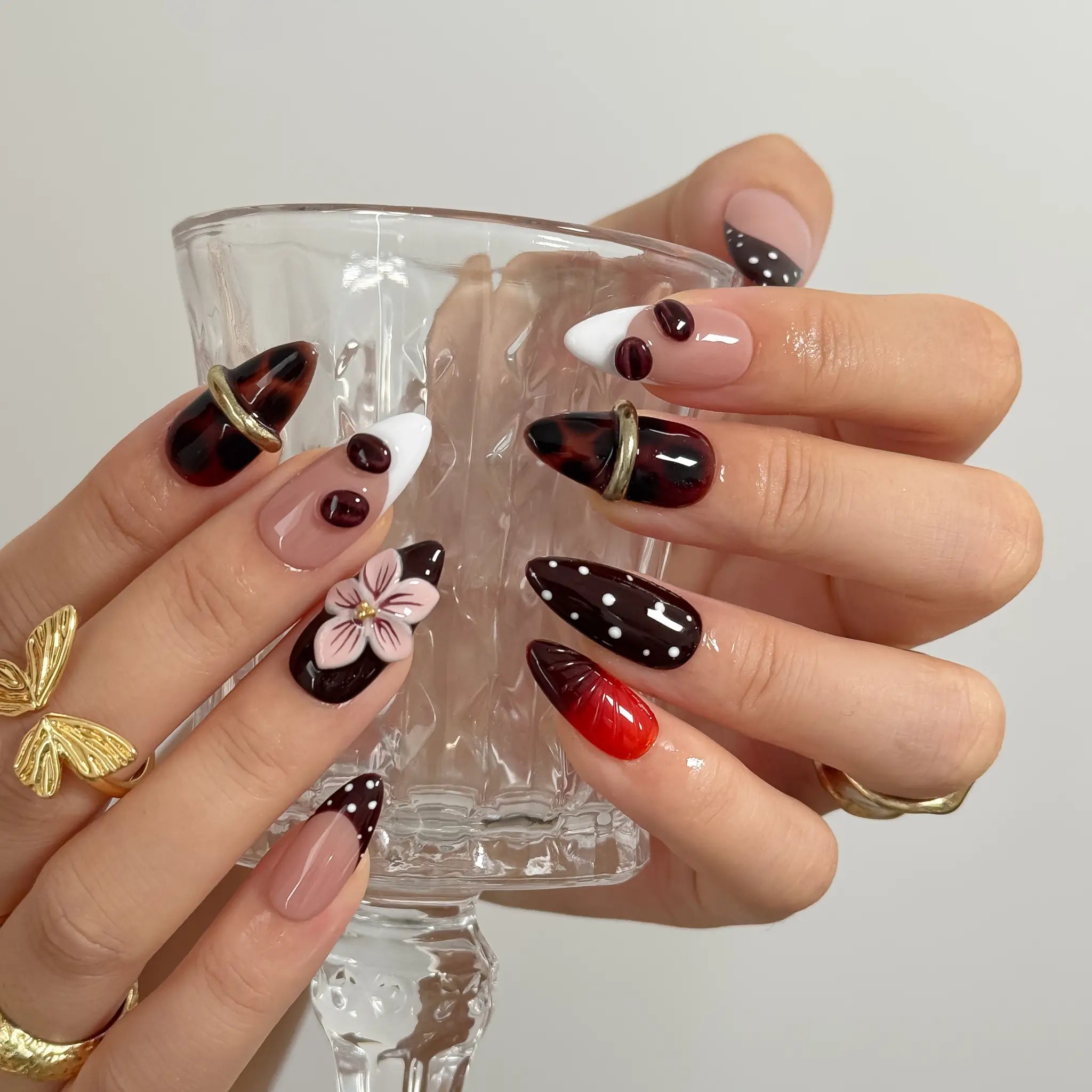 Cherry Noir Petals Long Almond press-on nails, modeled detail view 2