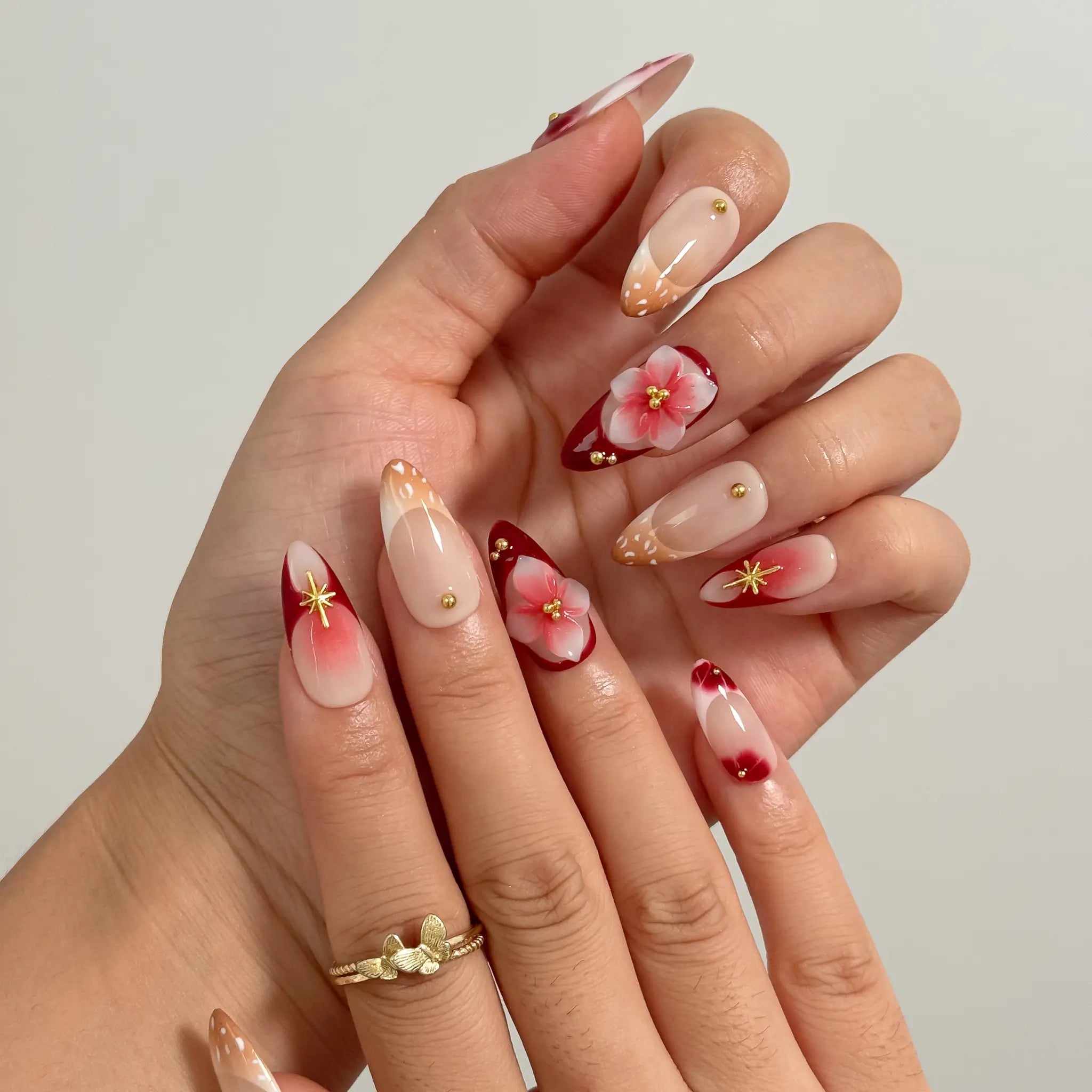 Crimson Bloom Compass Long Almond press-on nails, modeled detail view 2