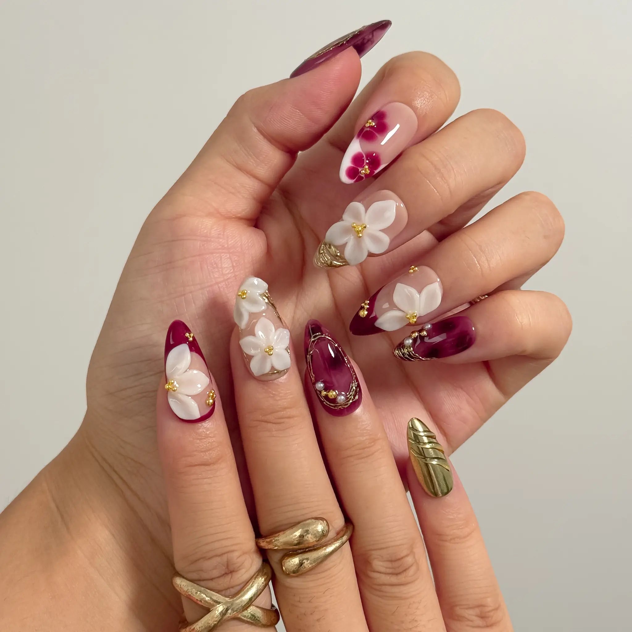 Burgundy Petal Heirloom Long Almond press-on nails, modeled detail view 1