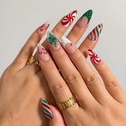 Peppermint Tree Parade press-on nails shown on hand