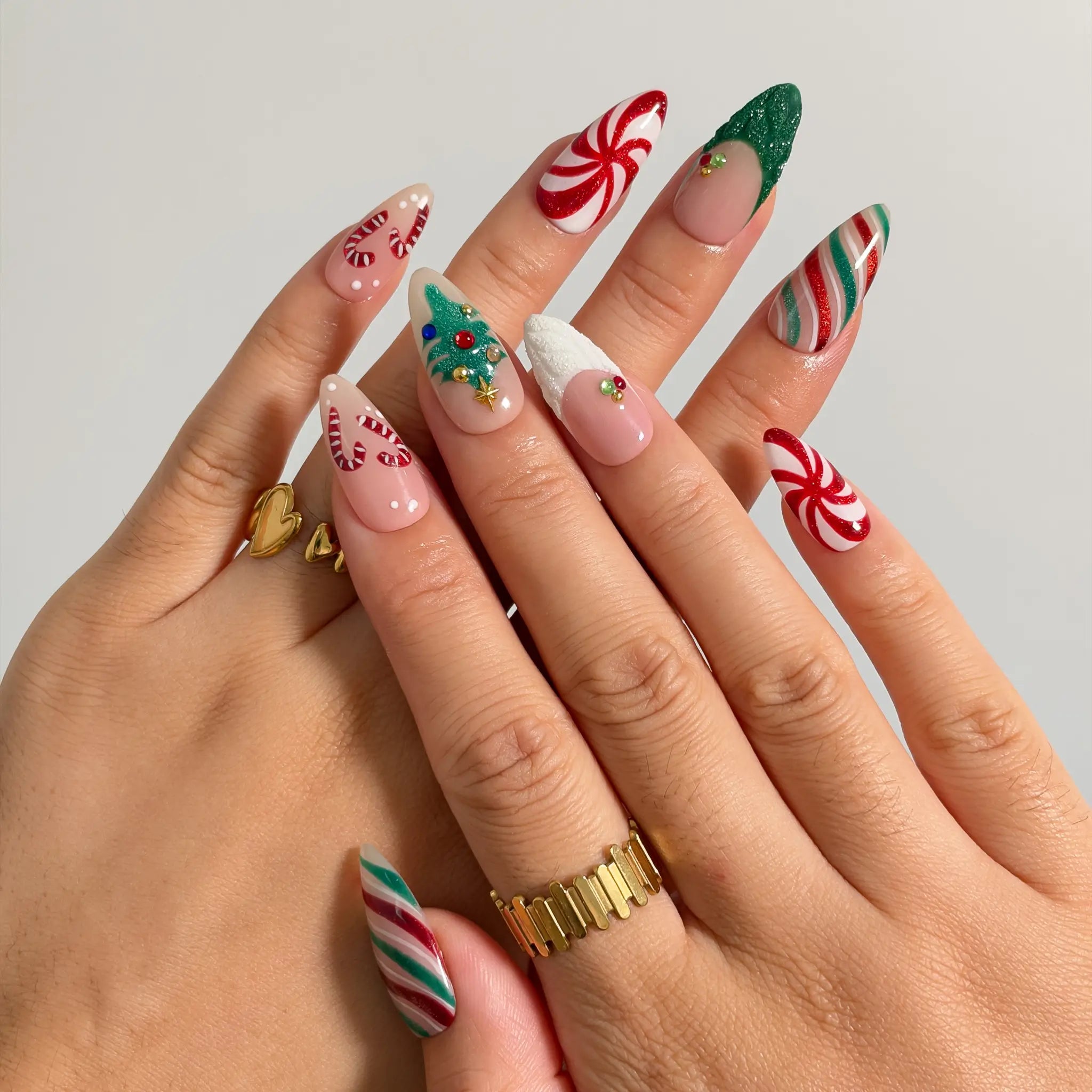 Peppermint Tree Parade press-on nails shown on hand