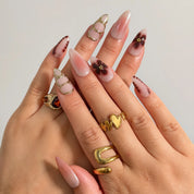 Mocha Petal Gilding press-on nails shown on hand