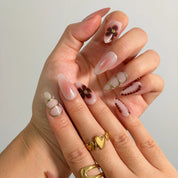 Mocha Petal Gilding Long Almond press-on nails, modeled detail view 1