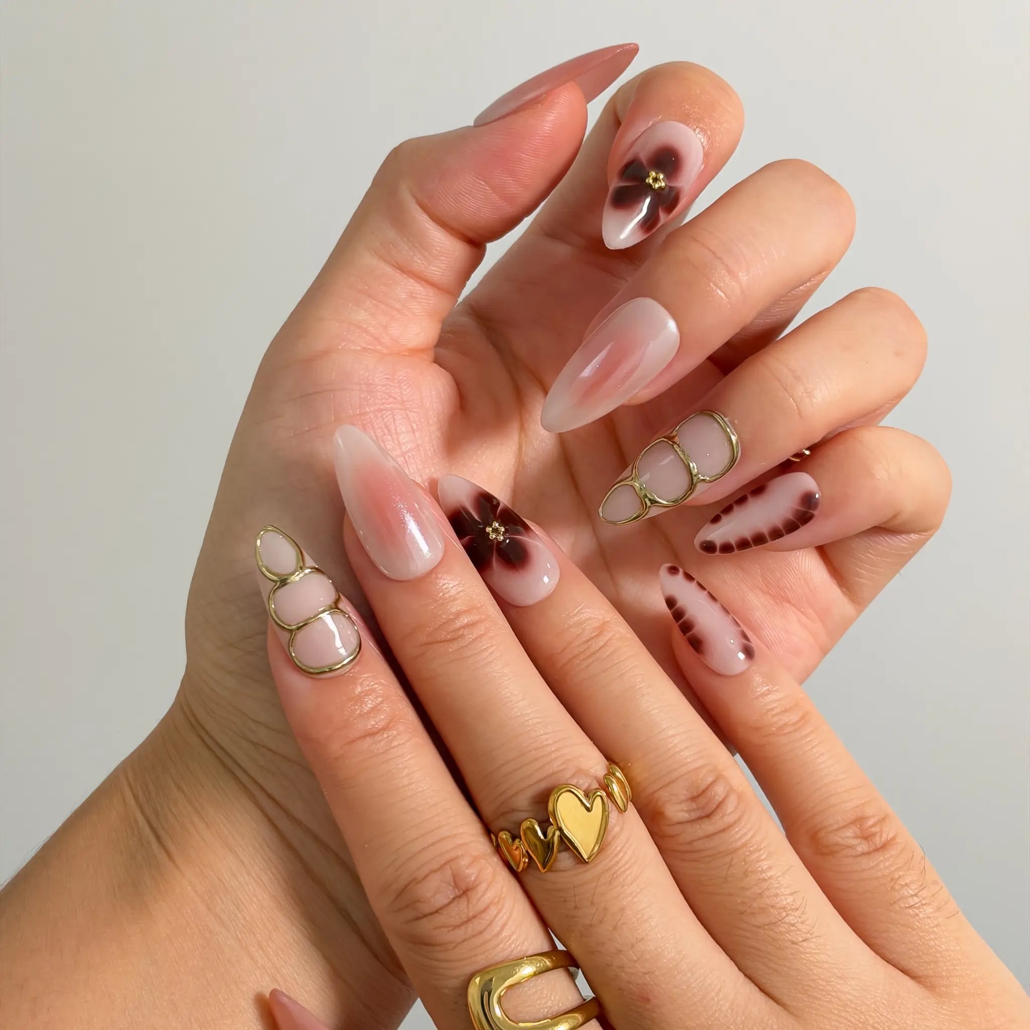 Mocha Petal Gilding Long Almond press-on nails, modeled detail view 1