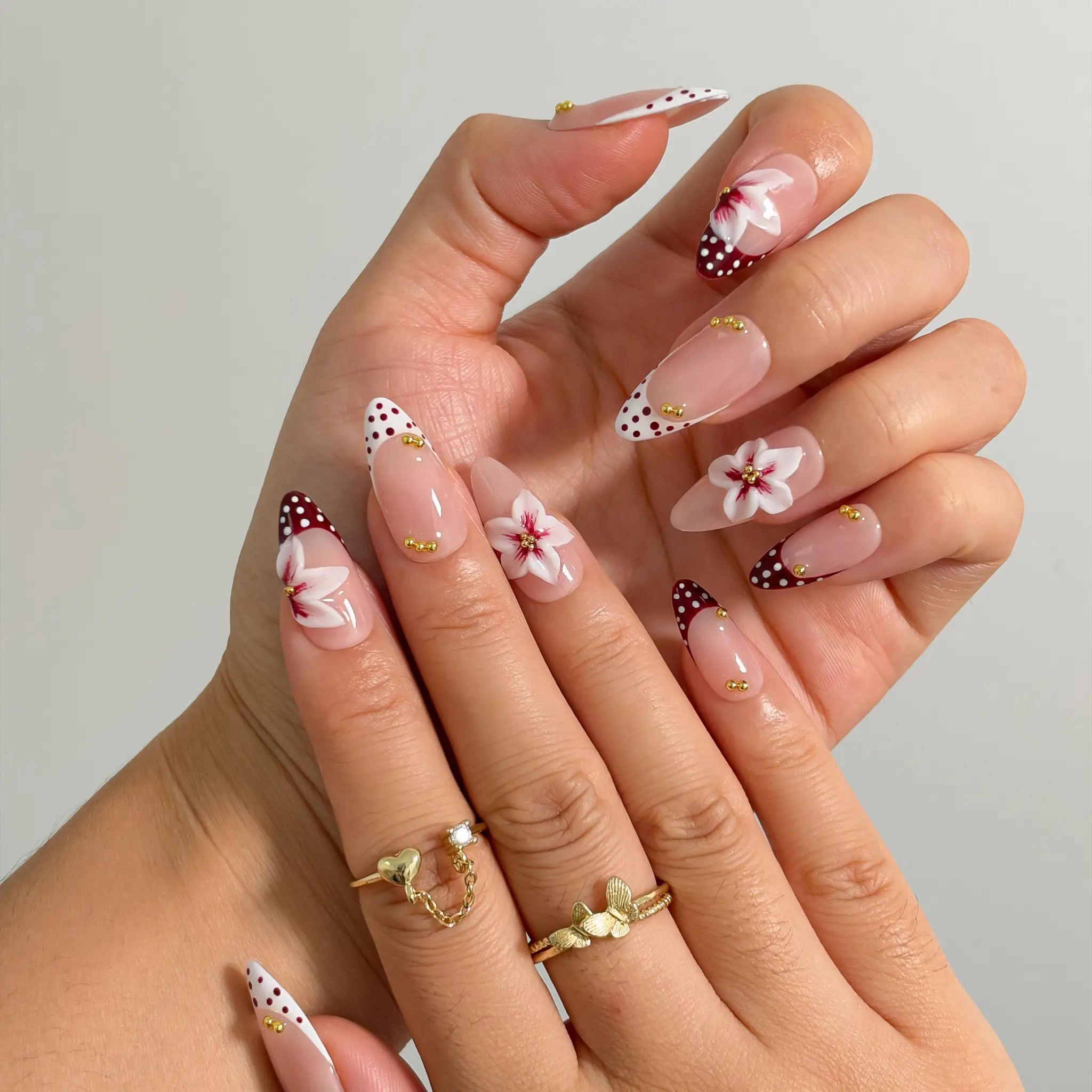 Poinsettia Dot Noel Long Almond press-on nails, modeled detail view 1