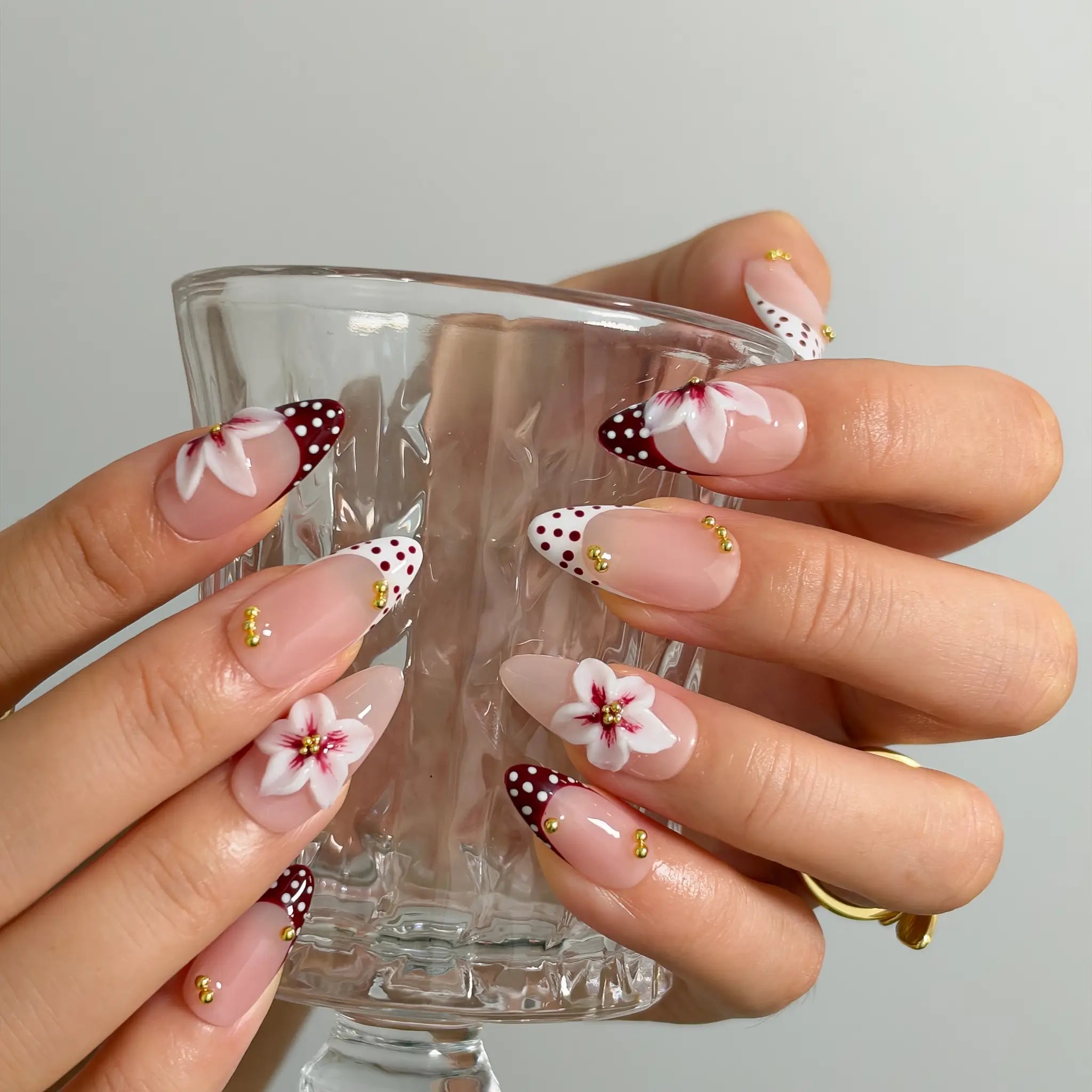 Poinsettia Dot Noel Long Almond press-on nails, modeled detail view 2
