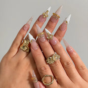 Ivory Baroque Halo press-on nails shown on hand