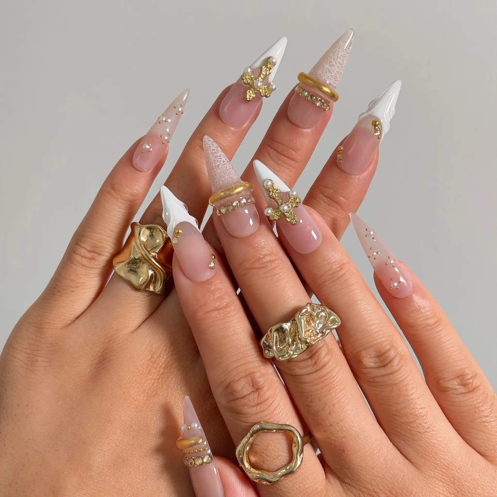 Ivory Baroque Halo press-on nails shown on hand