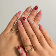 Rose Garden Gilded press-on nails shown on hand
