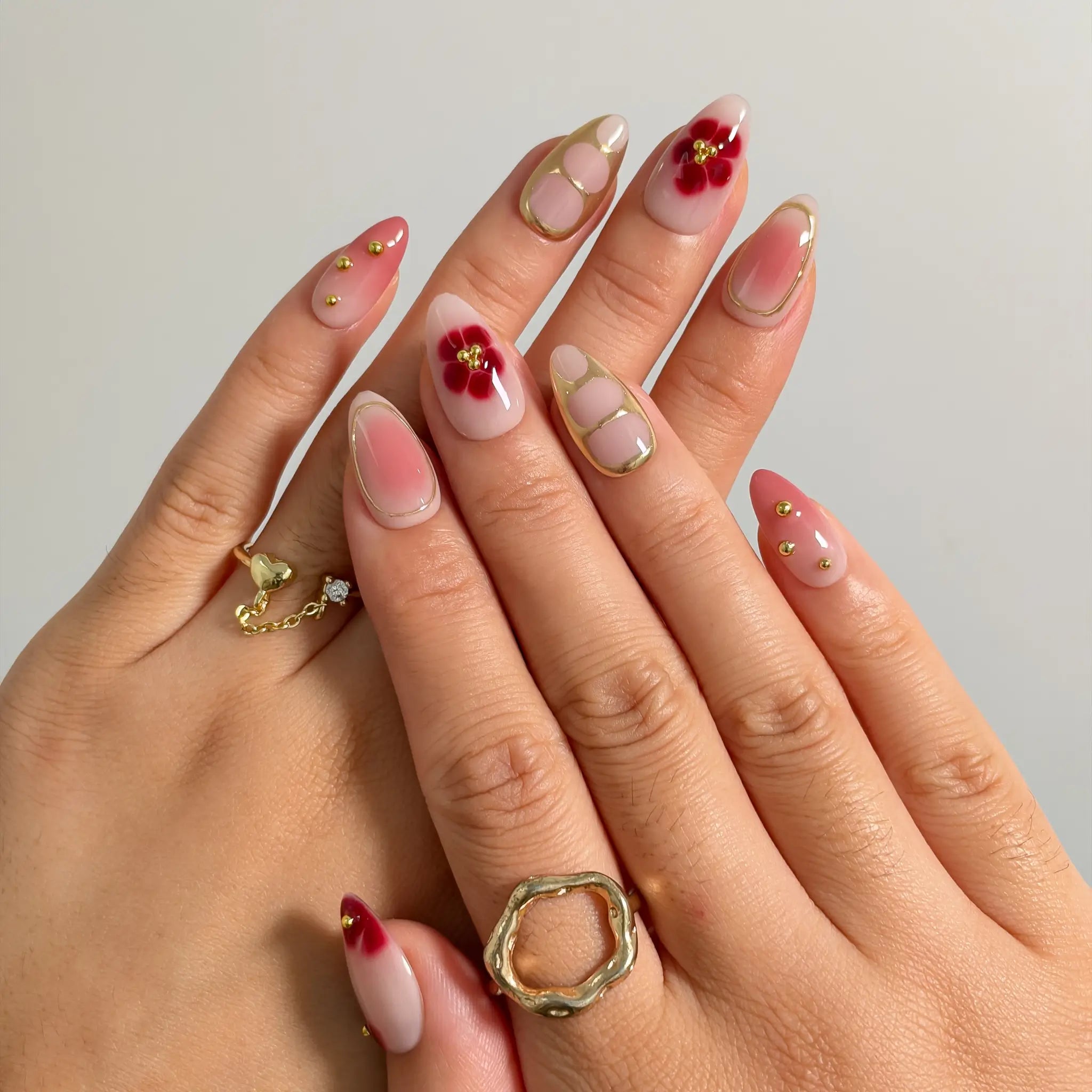 Rose Garden Gilded press-on nails shown on hand