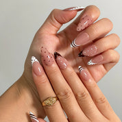 Cocoa Dot French Long Almond press-on nails, modeled detail view 1