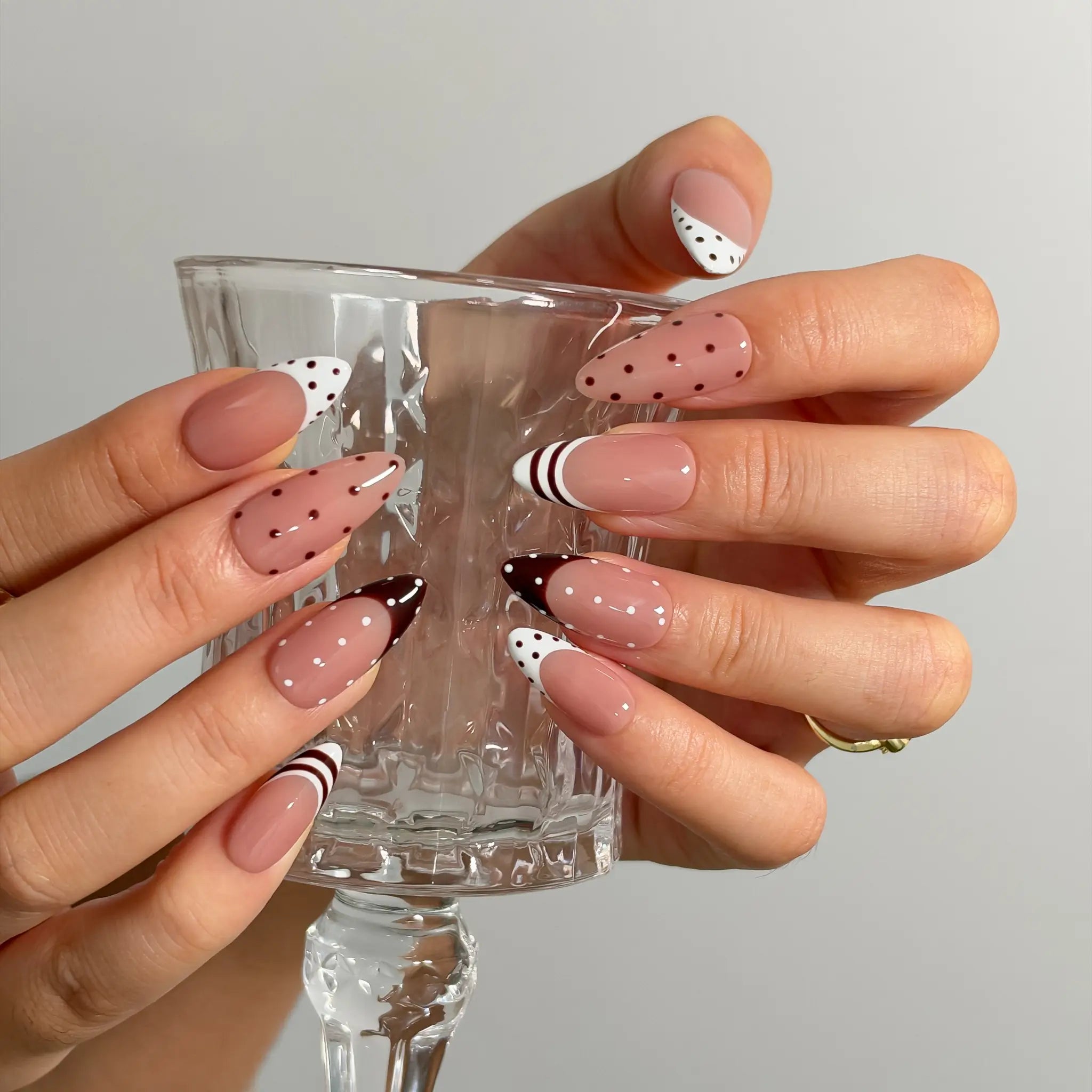 Cocoa Dot French Long Almond press-on nails, modeled detail view 2