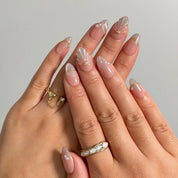 Pearl Shell Whisper press-on nails shown on hand