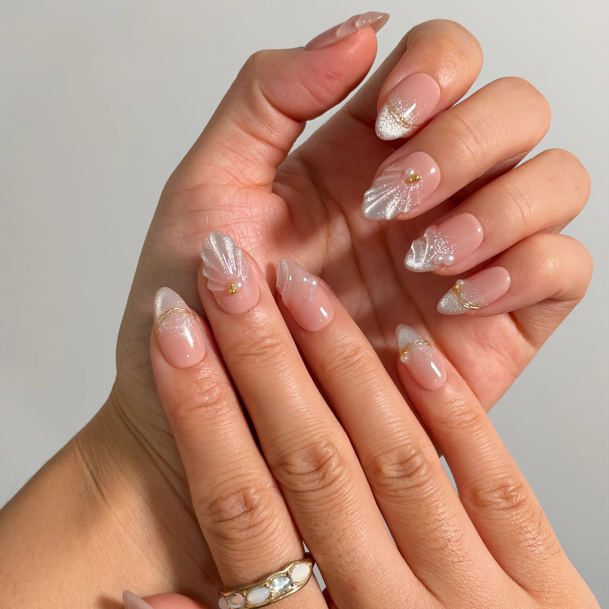 Pearl Shell Whisper Long Almond press-on nails, modeled detail view 1