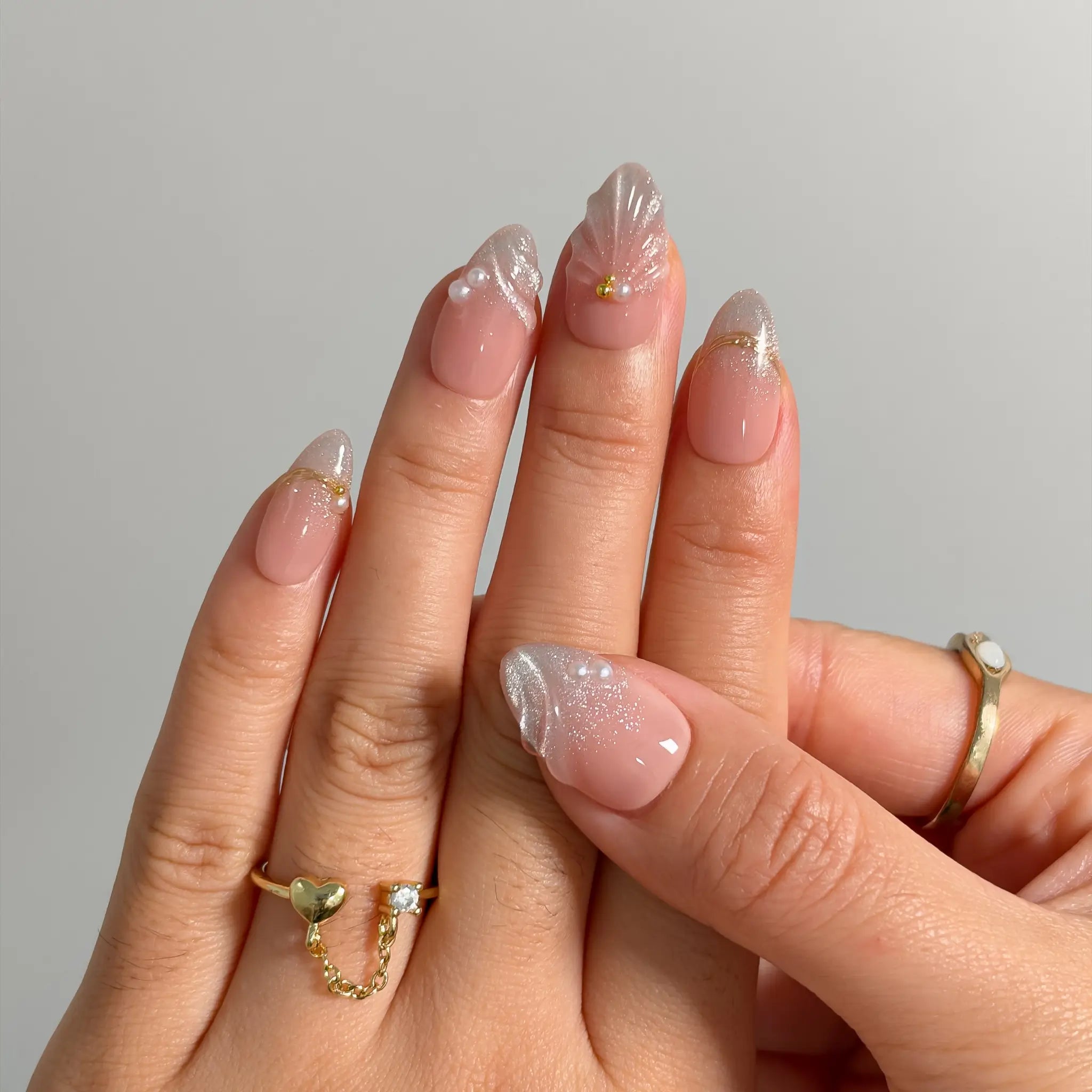 Pearl Shell Whisper Long Almond press-on nails, modeled detail view 2