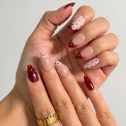 Burgundy Dot Reverie Long Almond press-on nails, modeled detail view 1