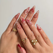 Garnet Ribbon Shimmer press-on nails shown on hand
