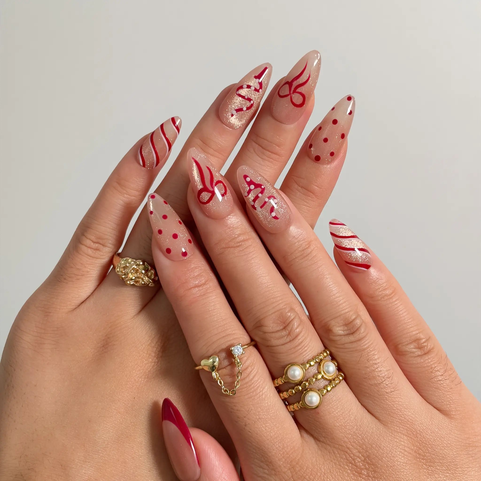 Garnet Ribbon Shimmer press-on nails shown on hand