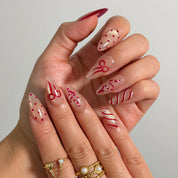 Garnet Ribbon Shimmer Long Almond press-on nails, modeled detail view 1