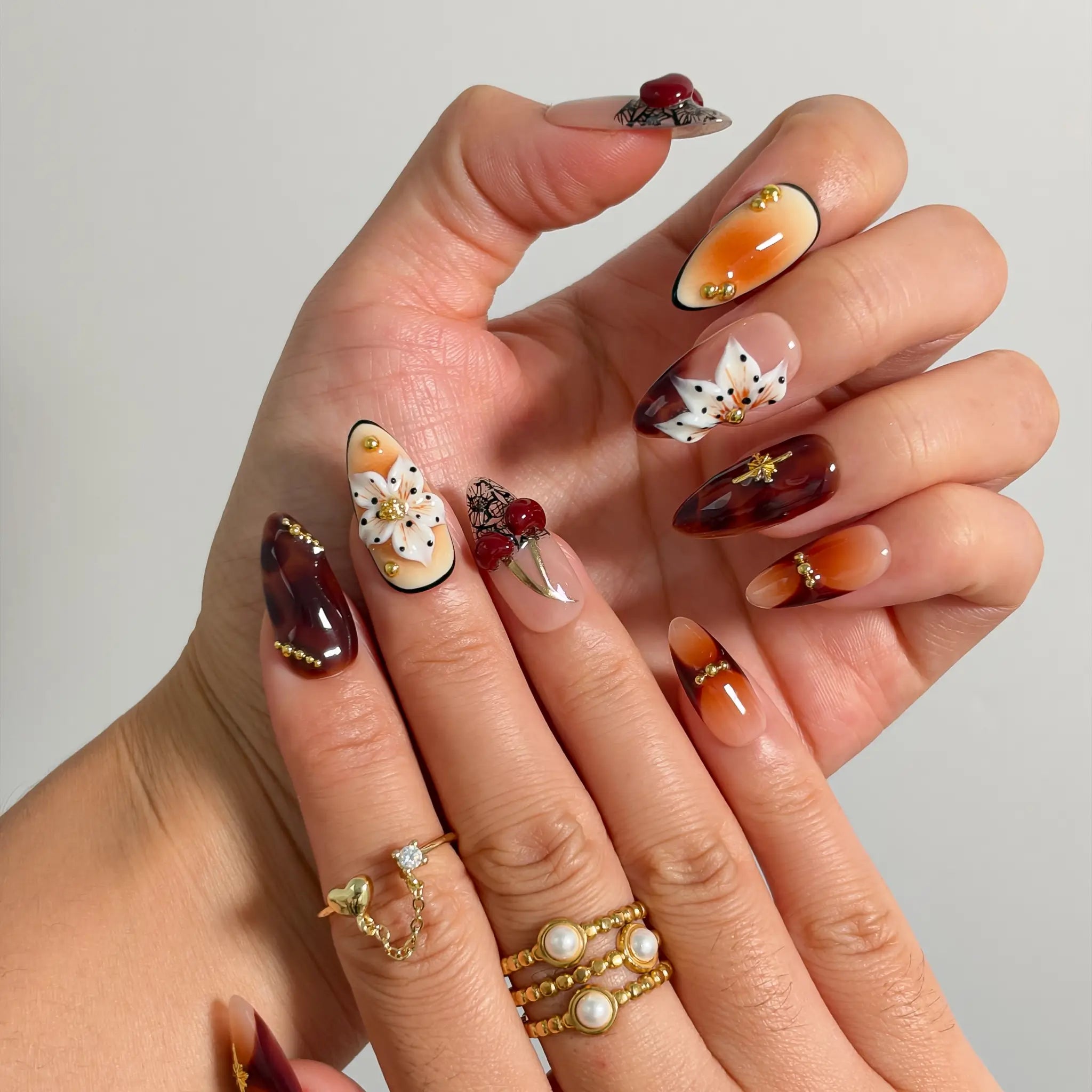 Amber Botanical Heirloom Long Almond press-on nails, modeled detail view 1