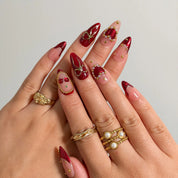 Cherry Ribbon Gala press-on nails shown on hand