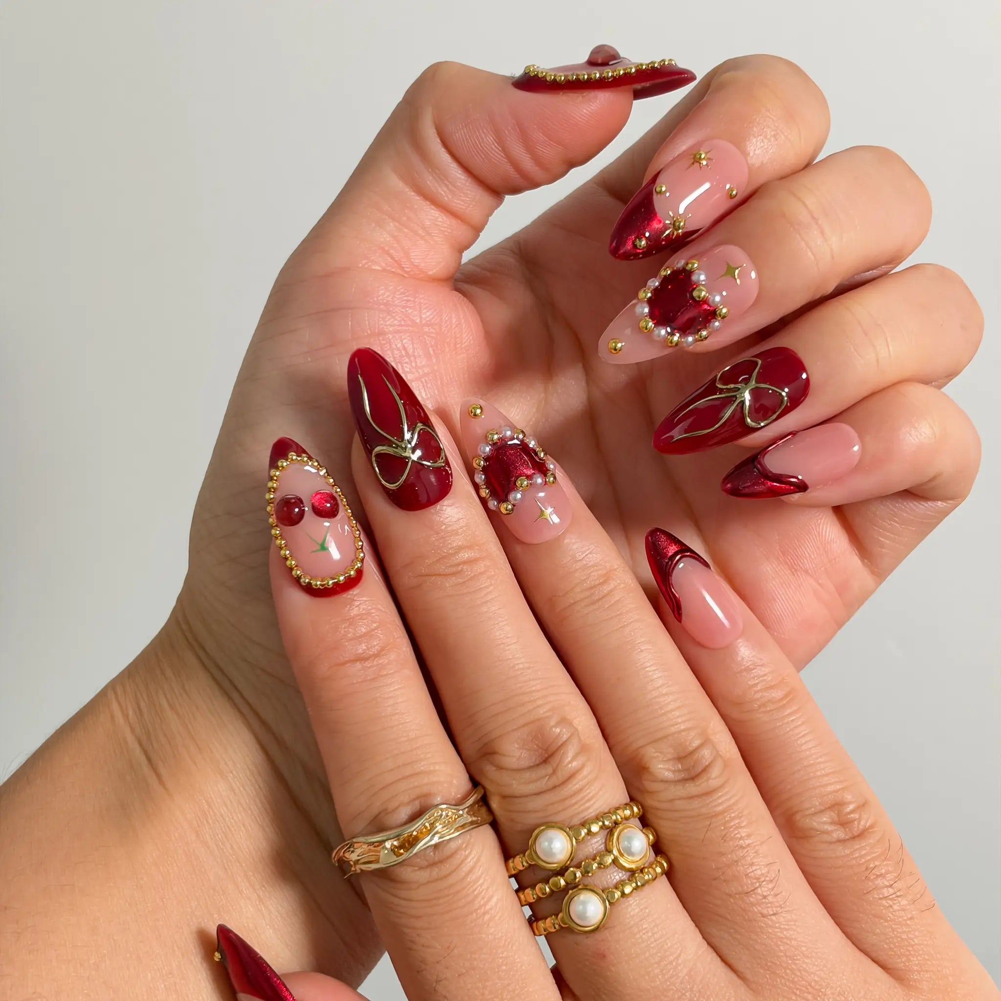 Cherry Ribbon Gala Long Almond press-on nails, modeled detail view 1