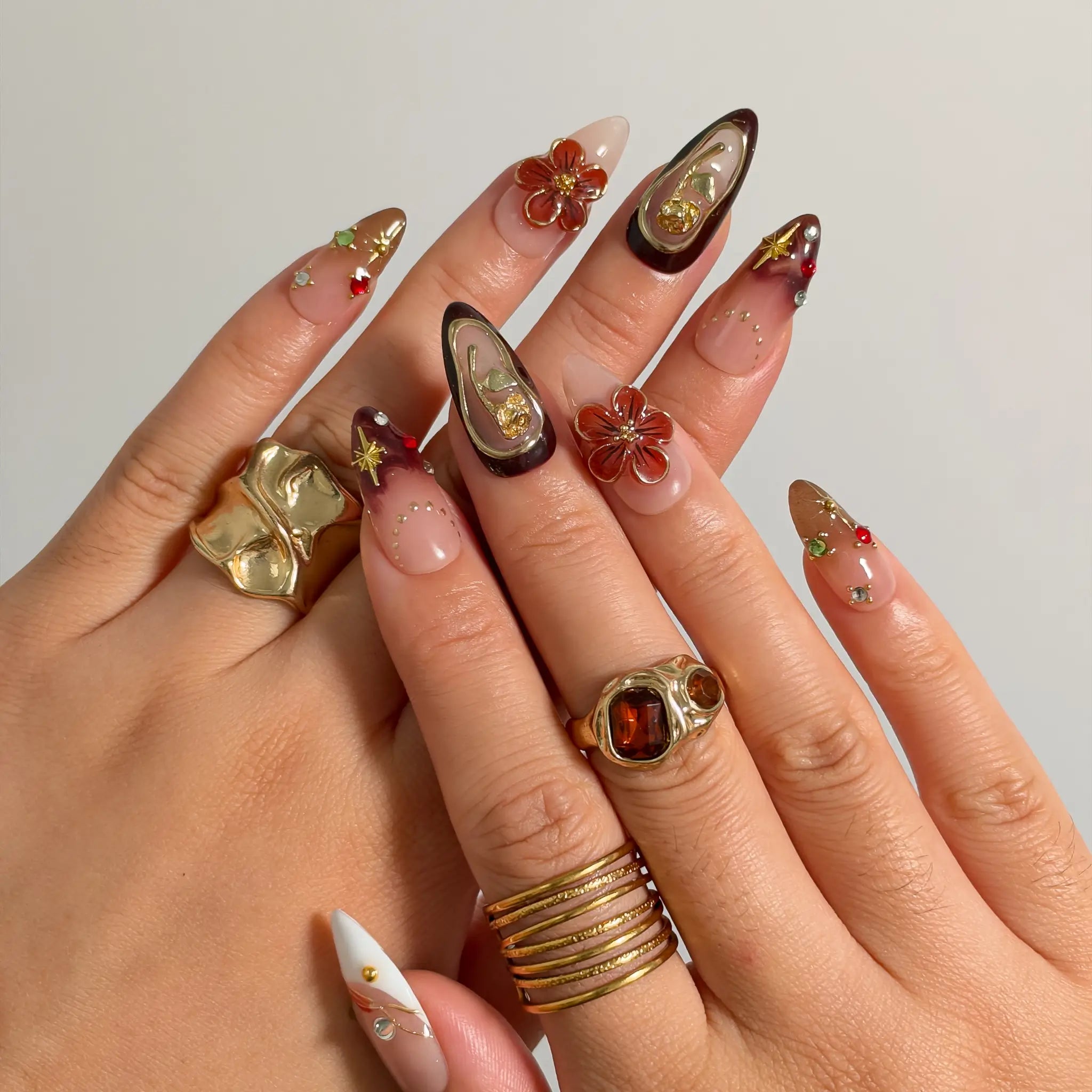 Mocha Gilded Relic press-on nails shown on hand