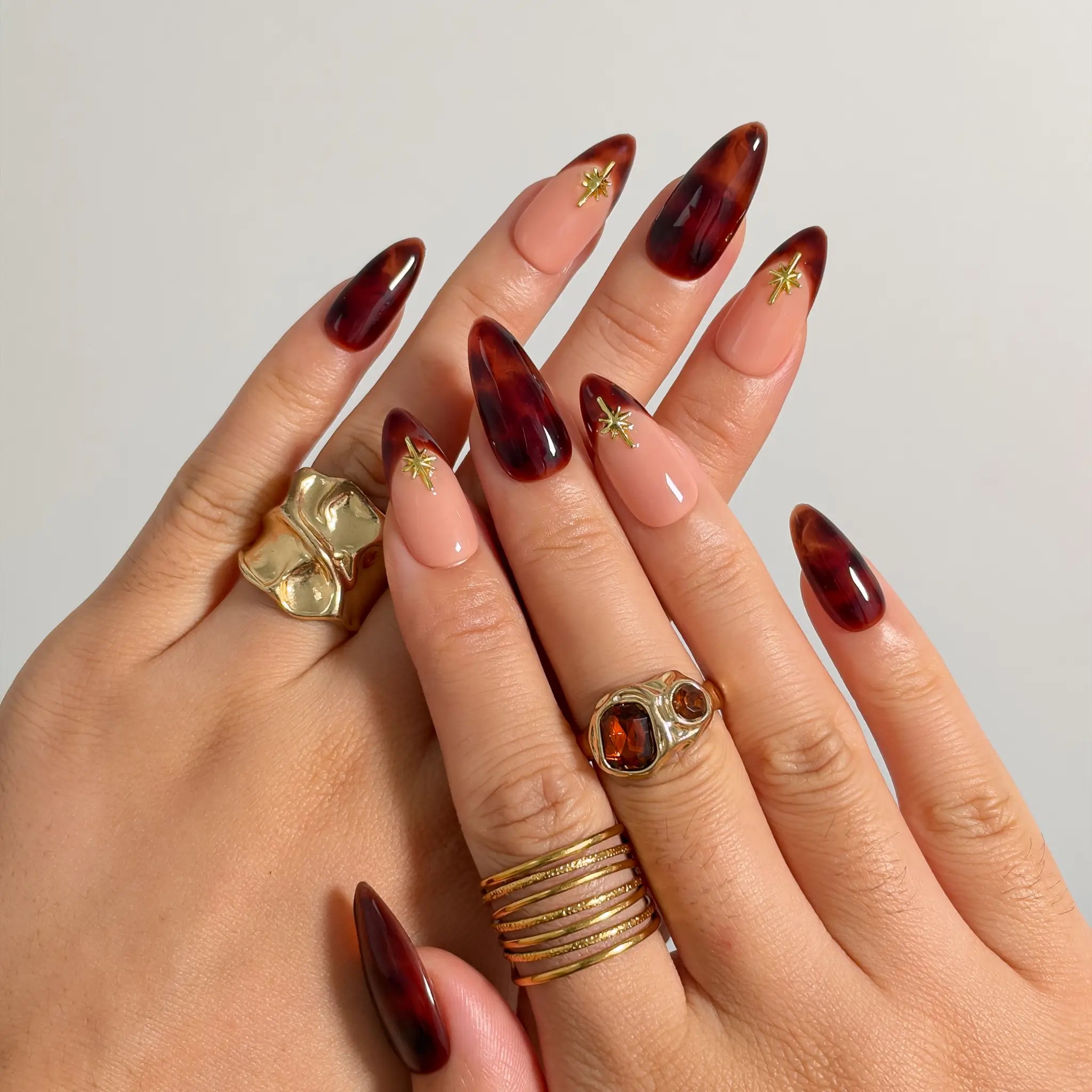 Tortoiseshell Golden Ember press-on nails shown on hand