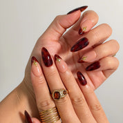 Tortoiseshell Golden Ember Long Almond press-on nails, modeled detail view 1
