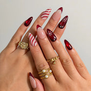 Crimson Peppermint Veil press-on nails shown on hand