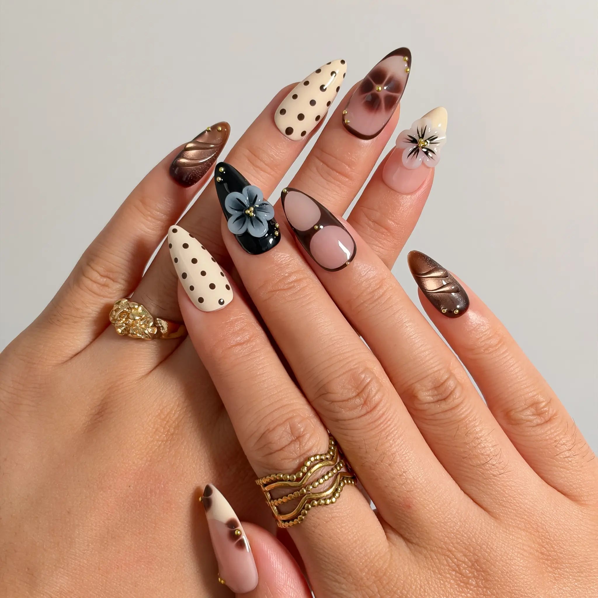 Noir Polka Bloom press-on nails shown on hand