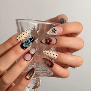 Noir Polka Bloom Long Almond press-on nails, modeled detail view 2