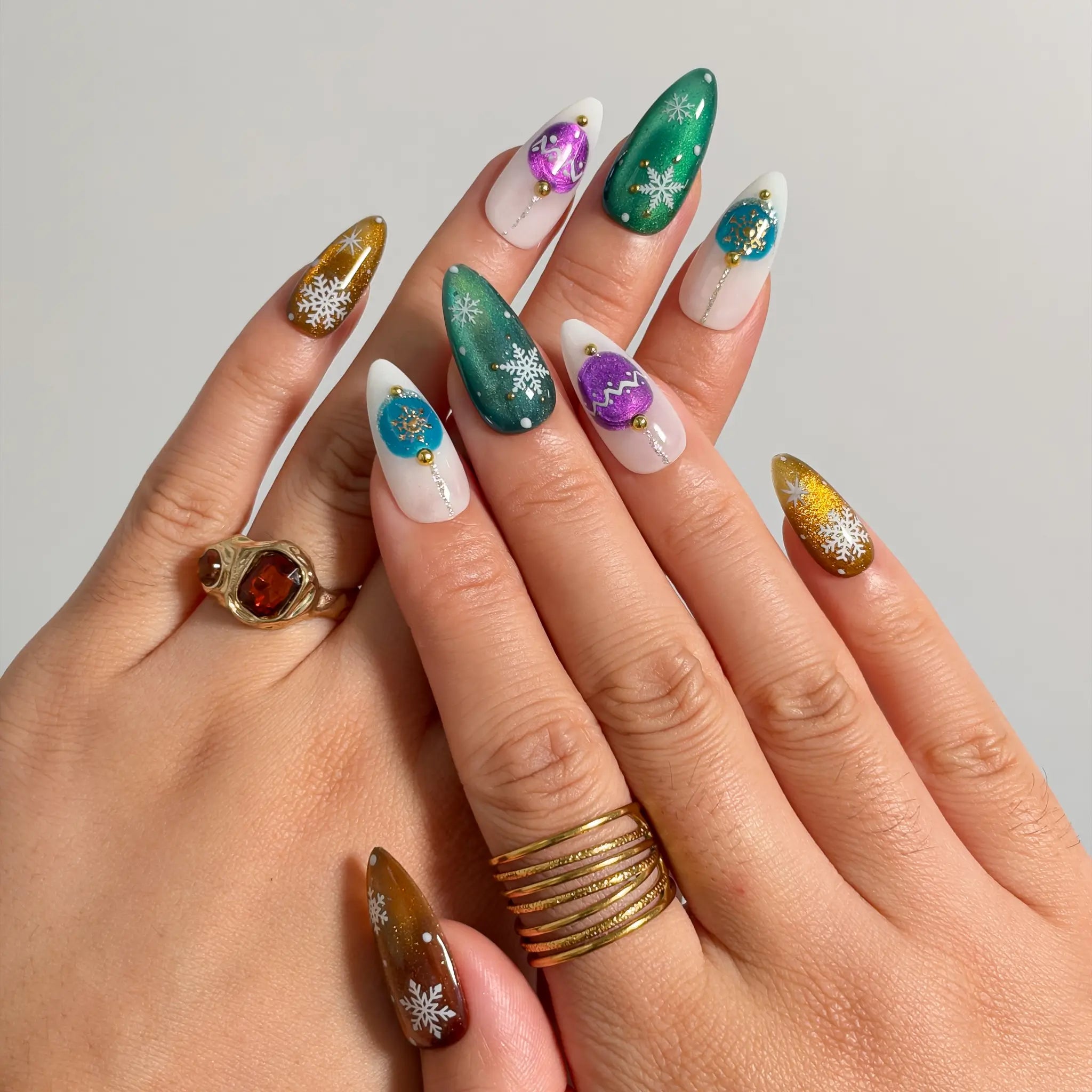 Ornament Snowfall Waltz press-on nails shown on hand