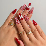 Crimson Heart Parade press-on nails shown on hand