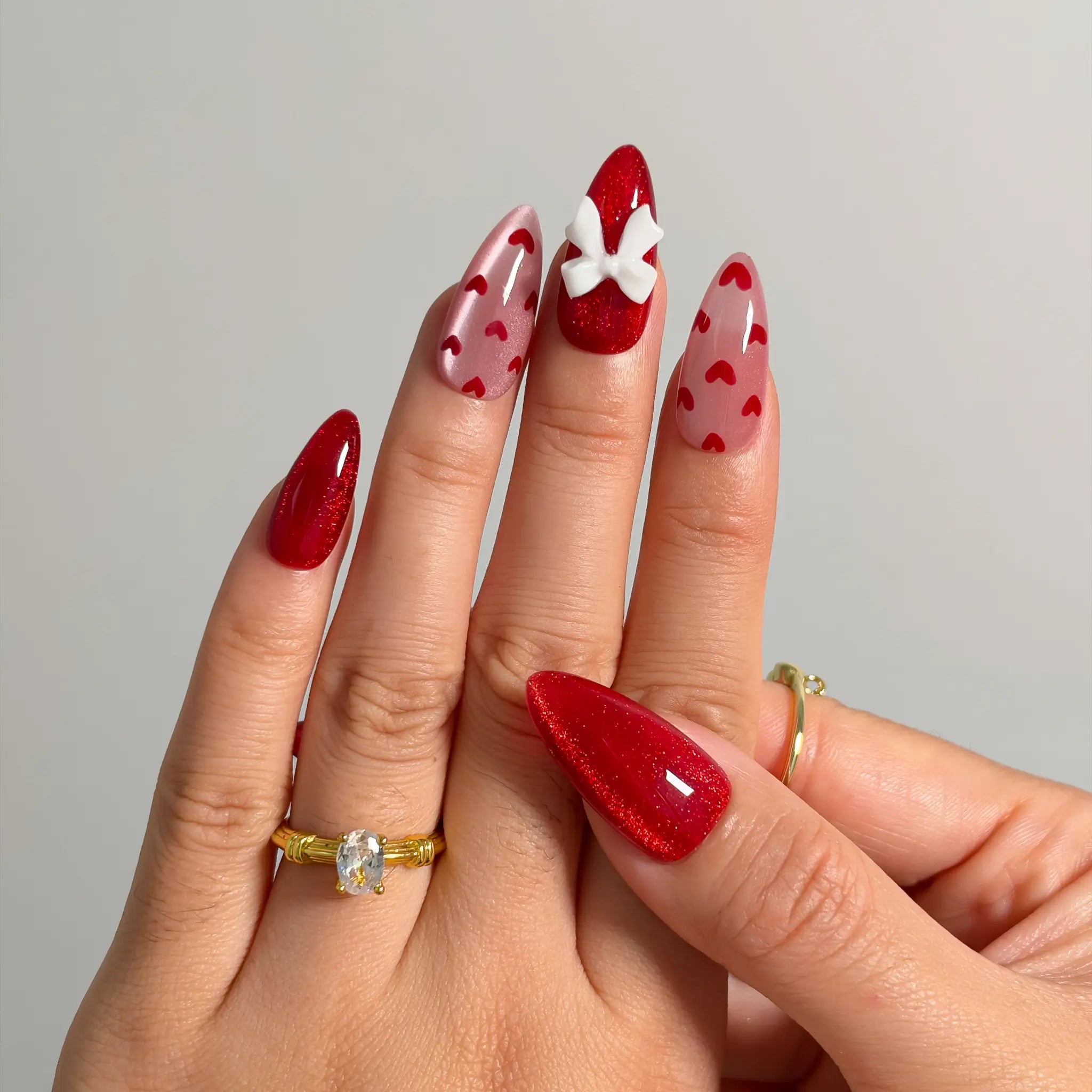 Crimson Heart Parade Long Almond press-on nails, modeled detail view 2