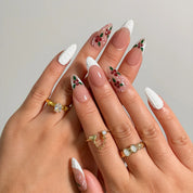 Candy Cane Snow Kiss press-on nails shown on hand