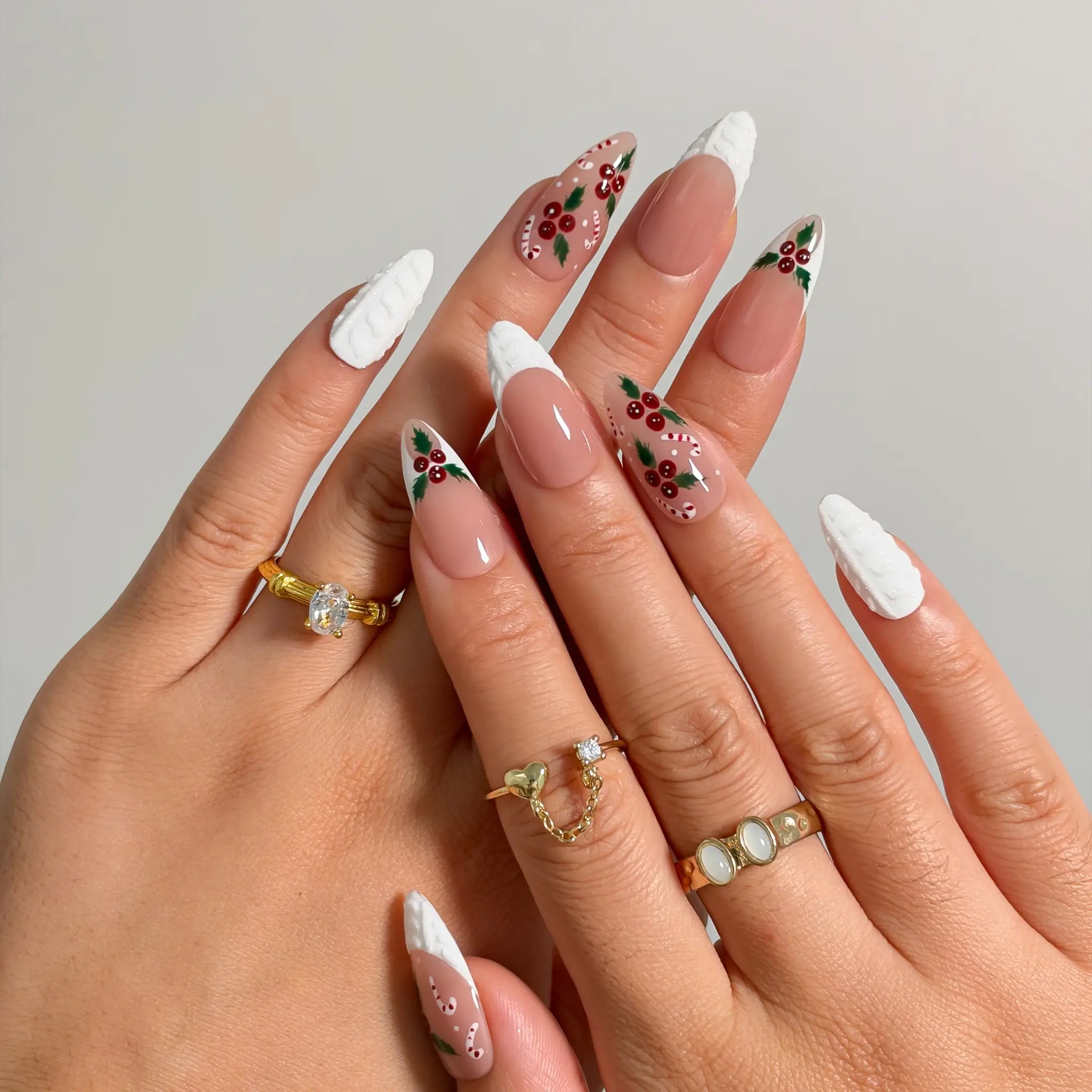 Candy Cane Snow Kiss press-on nails shown on hand