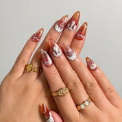 Gingerbread Frosting Dream press-on nails shown on hand