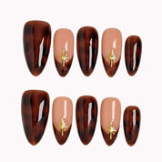 Tortoiseshell Golden Ember press-on nails in Brown, Nude, Gold on a white background
