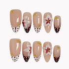 Poinsettia Dot Noel press-on nails in Nude, Burgundy, White on a white background