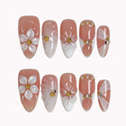 Ivory Petal Reverie press-on nails in Nude, White, Gold on a white background