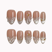 Pearl Shell Whisper press-on nails in Nude, White, Gold on a white background