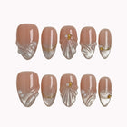 Pearl Shell Whisper press-on nails in Nude, White, Gold on a white background