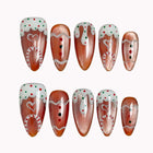 Gingerbread Frosting Dream press-on nails in Brown, White, Red on a white background