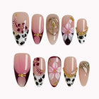 Burgundy Wildflower Muse press-on nails in Pink, Red, Gold on a white background
